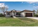 Single-story home with attached garage and landscaped lawn at 4310 Zenith Rd, Venice, FL 34293