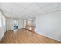 Open living area with light laminate flooring and access to a screened porch at 4953 Sea Island Ave, Sarasota, FL 34234