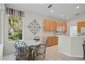 Kitchen features a breakfast nook and wood cabinets at 5351 Laurel Oak Ct, North Port, FL 34287
