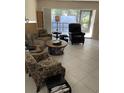 Bright living room featuring comfortable seating and large windows at 7030 W Country Club N Dr # 128, Sarasota, FL 34243