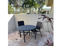 Small patio with table and chairs, perfect for outdoor dining at 7030 W Country Club N Dr # 128, Sarasota, FL 34243