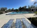 Community pool with lounge chairs for relaxing at 7030 W Country Club N Dr # 128, Sarasota, FL 34243