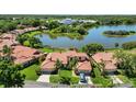 Aerial view showcasing community lakefront homes at 7361 Oak Moss Dr # 34, Sarasota, FL 34241