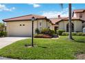 Exterior view of villa featuring a garage and landscaping at 7361 Oak Moss Dr # 34, Sarasota, FL 34241