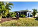 Landscaped backyard with lush greenery and screened patio at 804 Buttonwood Dr, Bradenton, FL 34208