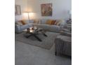 Spacious living room featuring a large sectional sofa and a stylish coffee table at 1002 Oakleaf Blvd, Bradenton, FL 34208