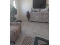 Bright living room with tiled floors, comfy seating, and large TV at 1002 Oakleaf Blvd, Bradenton, FL 34208