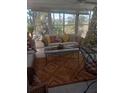 Relaxing sunroom boasts ample natural light and comfy seating at 1002 Oakleaf Blvd, Bradenton, FL 34208