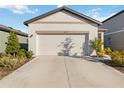 Single-story house with attached garage and neat landscaping at 10435 Ladybug Cv, Parrish, FL 34219