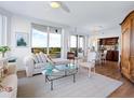 Spacious living room with hardwood floors, large windows, and ocean views at 1211 Gulf Of Mexico Dr # 301, Longboat Key, FL 34228