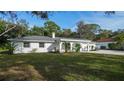 Newly renovated home exterior boasts a fresh white facade and landscaping at 1411 Quail Dr, Sarasota, FL 34231