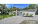 Newly renovated home exterior boasts a fresh white facade and landscaping at 1411 Quail Dr, Sarasota, FL 34231