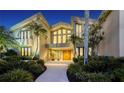 Elegant home with double doors and a lighted walkway at 1560 Harbor Sound Dr, Longboat Key, FL 34228