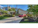 Luxury home with a red Corvette parked in the driveway at 1560 Harbor Sound Dr, Longboat Key, FL 34228