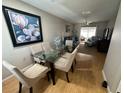 Bright dining room with glass table and four beige chairs at 1832 Sunny Dr # D32, Bradenton, FL 34207