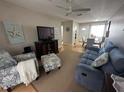 Living room with a blue couch and comfy armchair at 1832 Sunny Dr # D32, Bradenton, FL 34207