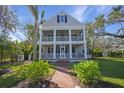 Two-story house with wrap-around porch and landscaped lawn at 320 29Th Nw St, Bradenton, FL 34205