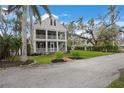 Two-story home with a large yard and palm trees at 320 29Th Nw St, Bradenton, FL 34205