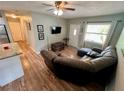 Spacious living area with comfortable seating and wood-look floors at 4521 85Th N Ave, Pinellas Park, FL 33781