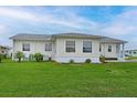 Rear view of house showing a large grassy yard at 4531 13Th E St, Ellenton, FL 34222