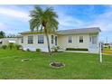 Single-story house with palm tree and well-maintained lawn at 4531 13Th E St, Ellenton, FL 34222