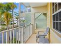 Private balcony with chair and view of tropical landscape and buildings at 521 Bahia Beach Blvd, Ruskin, FL 33570