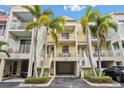 Bright yellow 3 story building with parking and tropical landscaping at 521 Bahia Beach Blvd, Ruskin, FL 33570