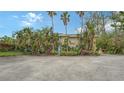 Exterior view of condo building with tropical landscaping at 5311 Gulf Of Mexico Dr # 3, Longboat Key, FL 34228