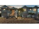 Two-story waterfront home with light blue siding and a brick driveway at 635 Key Royale Dr, Holmes Beach, FL 34217