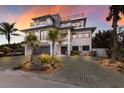 Modern coastal home with a beautiful sunset view and spacious driveway at 6605 Gulf Dr, Holmes Beach, FL 34217