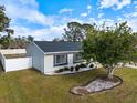 Well-maintained home, fenced backyard, and mature trees at 6756 Electra Ave, North Port, FL 34287