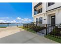 Front entrance of a modern townhouse with waterfront view at 7420 Newham Ln, Sarasota, FL 34240