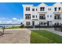 Modern, three-story waterfront townhome with private fenced yard at 7420 Newham Ln, Sarasota, FL 34240