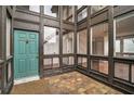 Condo entryway with teal door and tiled floor at 800 S Blvd Of Presidents # 12, Sarasota, FL 34236