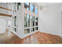 Bright living room with terracotta tile floors and high ceilings at 800 S Blvd Of Presidents # 12, Sarasota, FL 34236