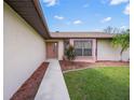 Inviting front entrance with a walkway leading to the front door at 8469 Cypress Lake Cir, Sarasota, FL 34243