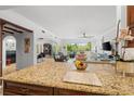 Spacious kitchen with granite countertops, dark wood cabinets, and views into living area at 866 Hudson Ave # 866, Sarasota, FL 34236