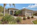 Well-maintained house with lush landscaping and a two-car garage at 872 Clear Lake Dr, Englewood, FL 34223