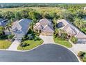 Luxury home community with lush landscaping and a tranquil lake at 8808 Enclave Ct, Sarasota, FL 34238