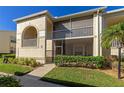 Exterior view of condo building with screened balcony and landscaping at 9480 High Gate Dr # 2111, Sarasota, FL 34238