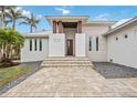 Modern home's entryway, featuring stone steps and a wood door at 103 Graham Se St, Port Charlotte, FL 33952