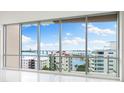 Living room showcasing stunning water and city views at 111 Golden Gate Pt # 701Ph, Sarasota, FL 34236