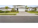 Two-story house on a tree lined street with a grassy lawn at 12409 Wigeon Dr, Bradenton, FL 34212