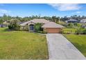 Single-story house, large backyard, and long driveway at 1572 Nimbus Dr, North Port, FL 34287