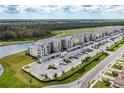 Aerial view of apartment buildings, parking, and a golf course at 18114 Gawthrop Dr # 404, Bradenton, FL 34211