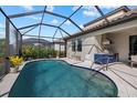 Enclosed pool area with a spacious deck and outdoor kitchen at 2028 Woodleaf Hammock Ct, Bradenton, FL 34211