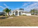 White house with palm trees and a grassy yard at 2053 Rio De Janeiro Ave, Punta Gorda, FL 33983