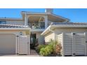 Exterior view of two-story home with landscaped yard and two car garage at 2195 Harbourside Dr # 404, Longboat Key, FL 34228