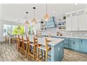 Spacious kitchen with light blue cabinets, quartz countertops, and an island at 2213 Avenue B, Bradenton Beach, FL 34217