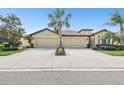 House exterior showcasing a three-car garage and neatly landscaped yard at 314 Mystic Falls Dr, Apollo Beach, FL 33572